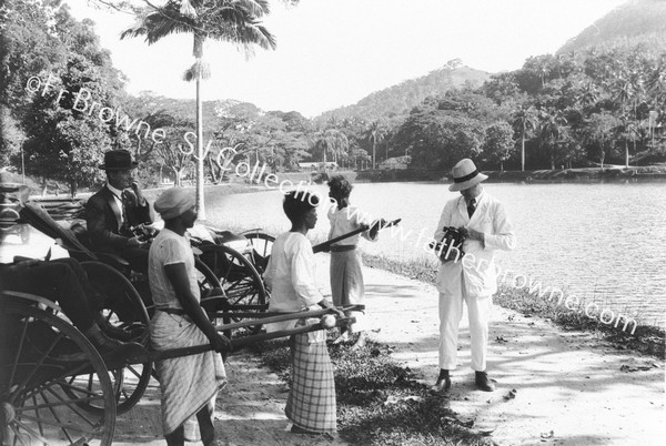 GROUP IN RICKSHAWS BESIDE LAKE